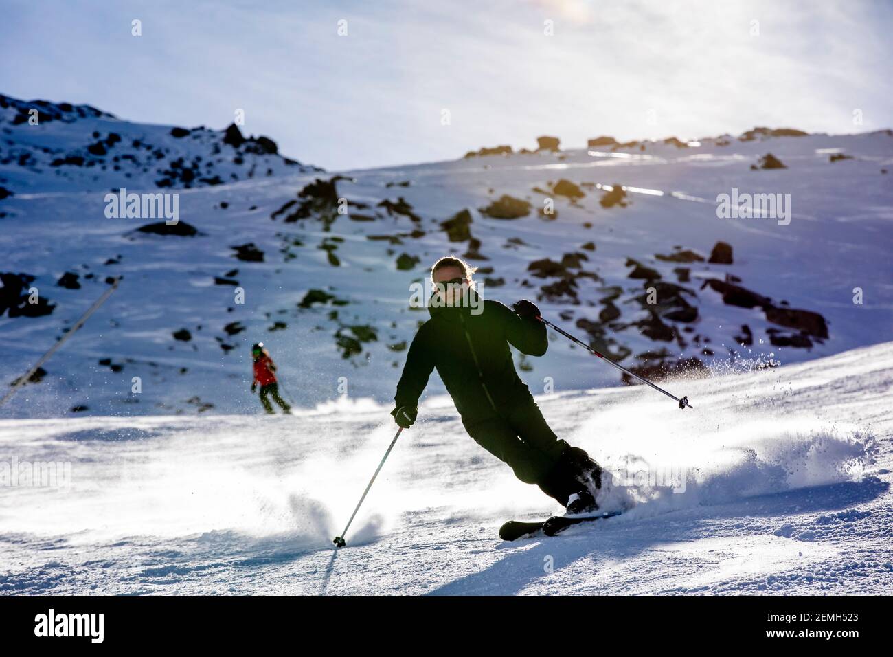 Val Thorens, France - February 21, 2020: Happy young man enjoying winter vacations in mountains, Val Thorens, 3 Valleys, France. Playing with snow and Stock Photo