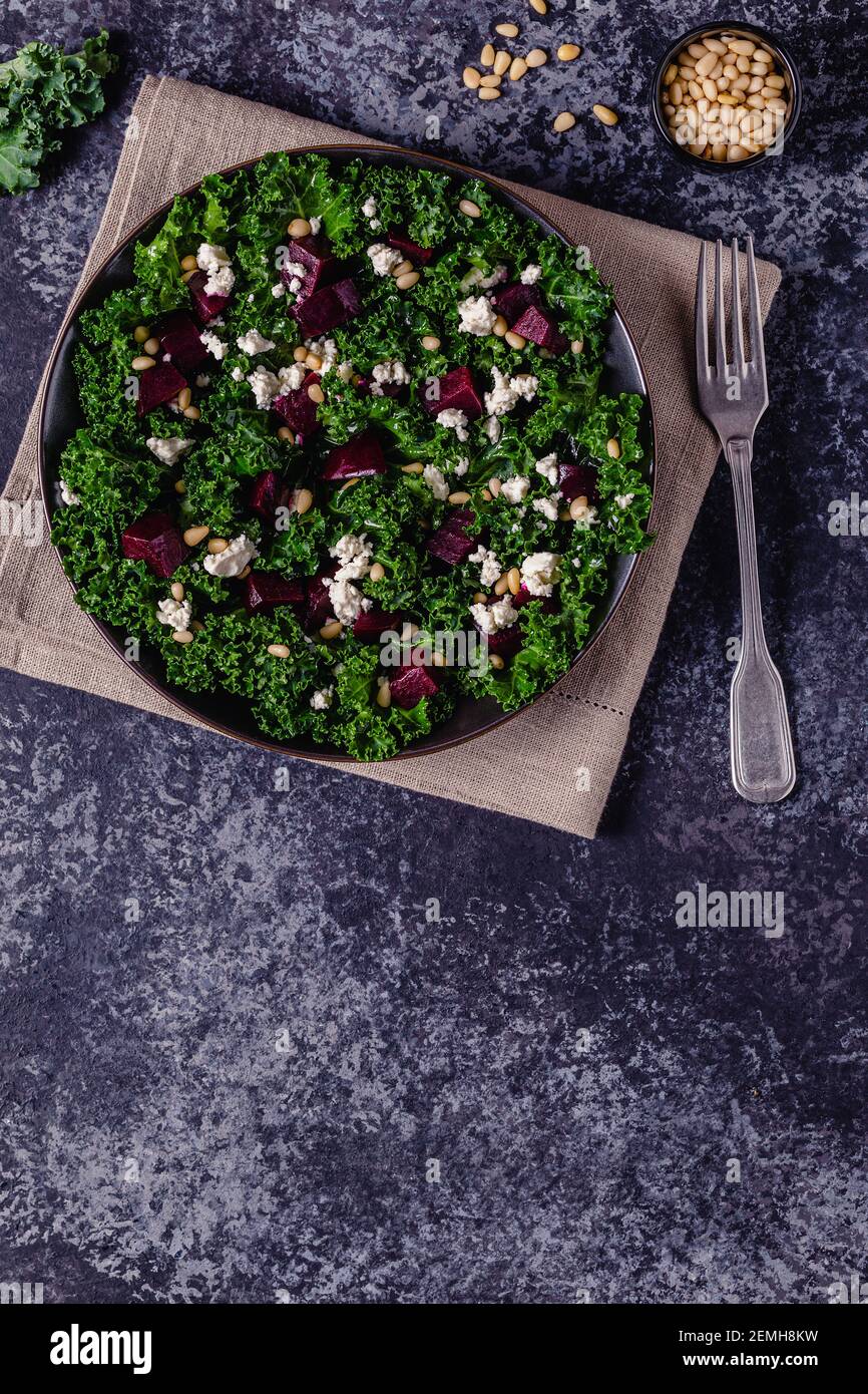 Healthy raw kale and beetroot salad with feta cheese and pine nut. Top