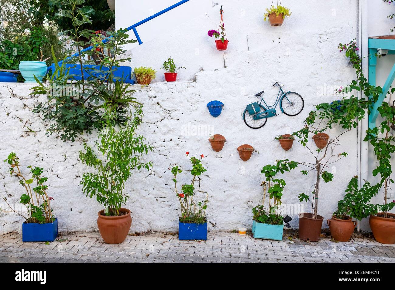 Decorated white wall with plants and bicycle, Kas, Turkey Stock Photo