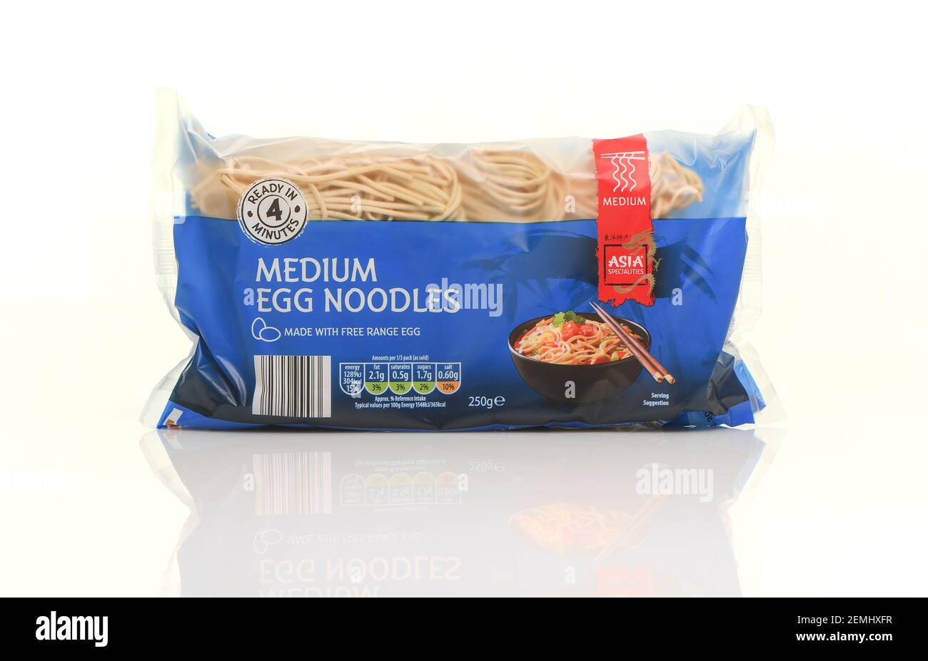 Packet of dried egg noodles made with free range egg from the Asia specialties Aldi range shot on a white background with reflection. Stock Photo