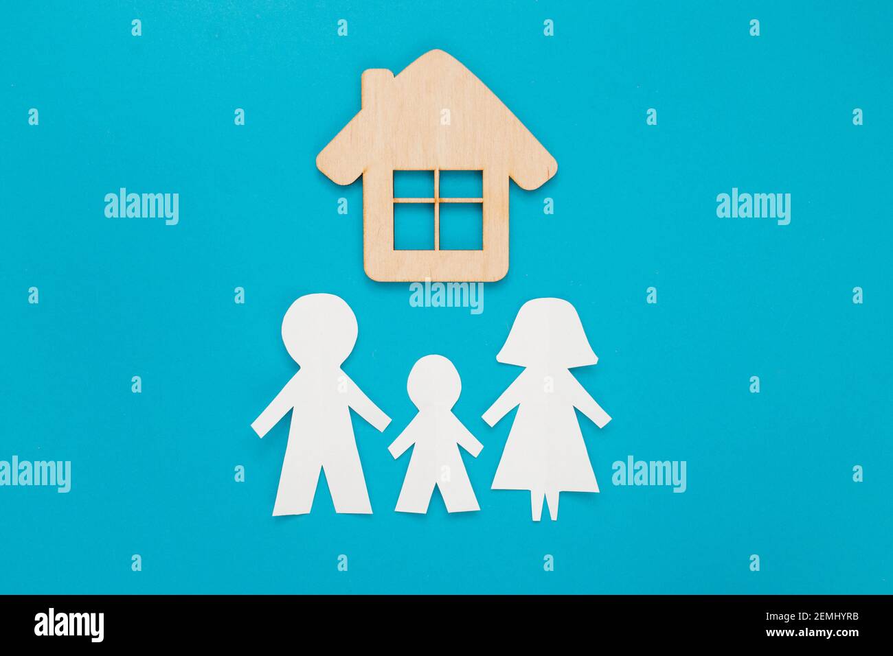 Family cut out paper with mini wood house model on blue background. Top ...
