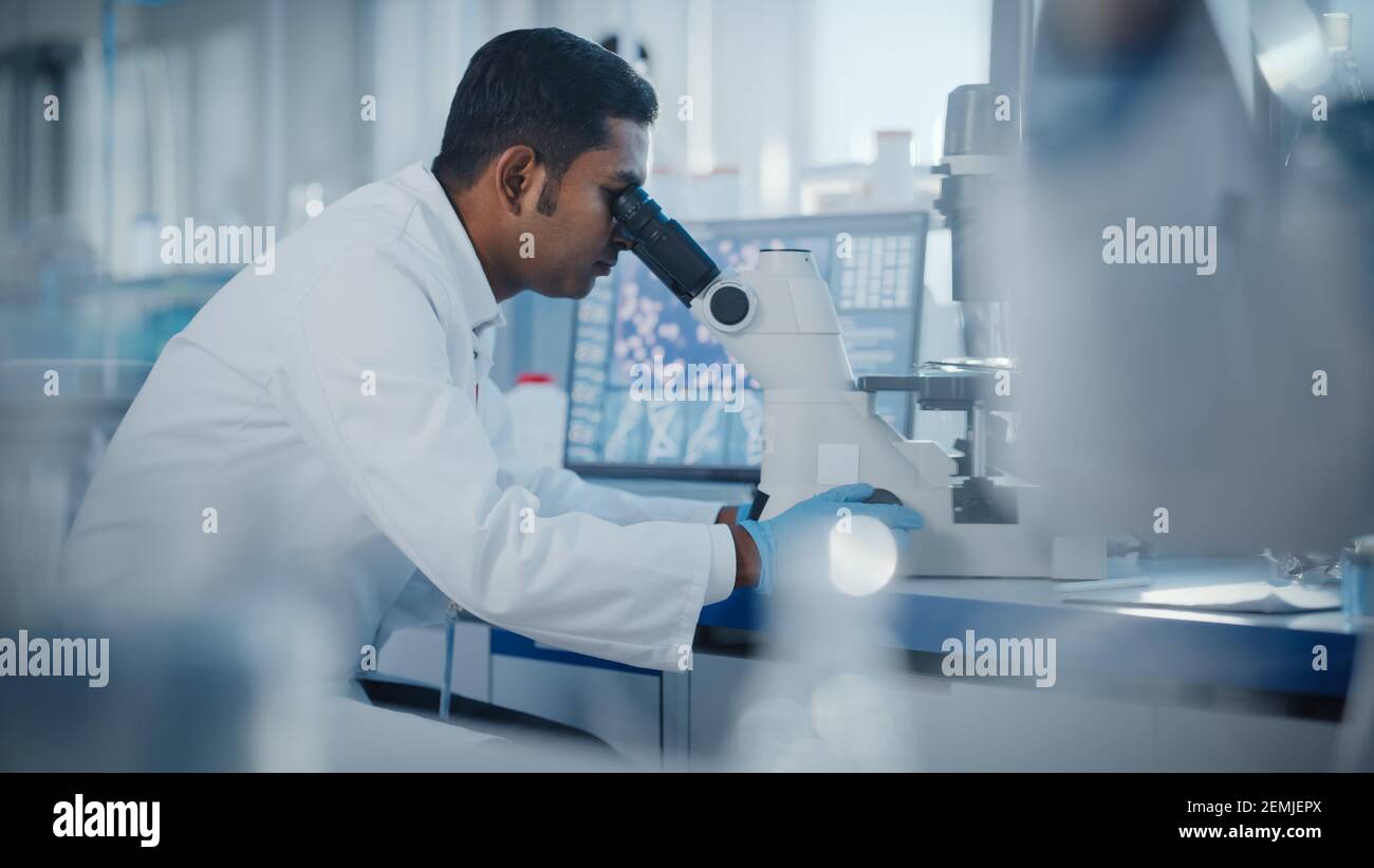 Medical Research Laboratory Male Scientist Looking Under Micrsocope