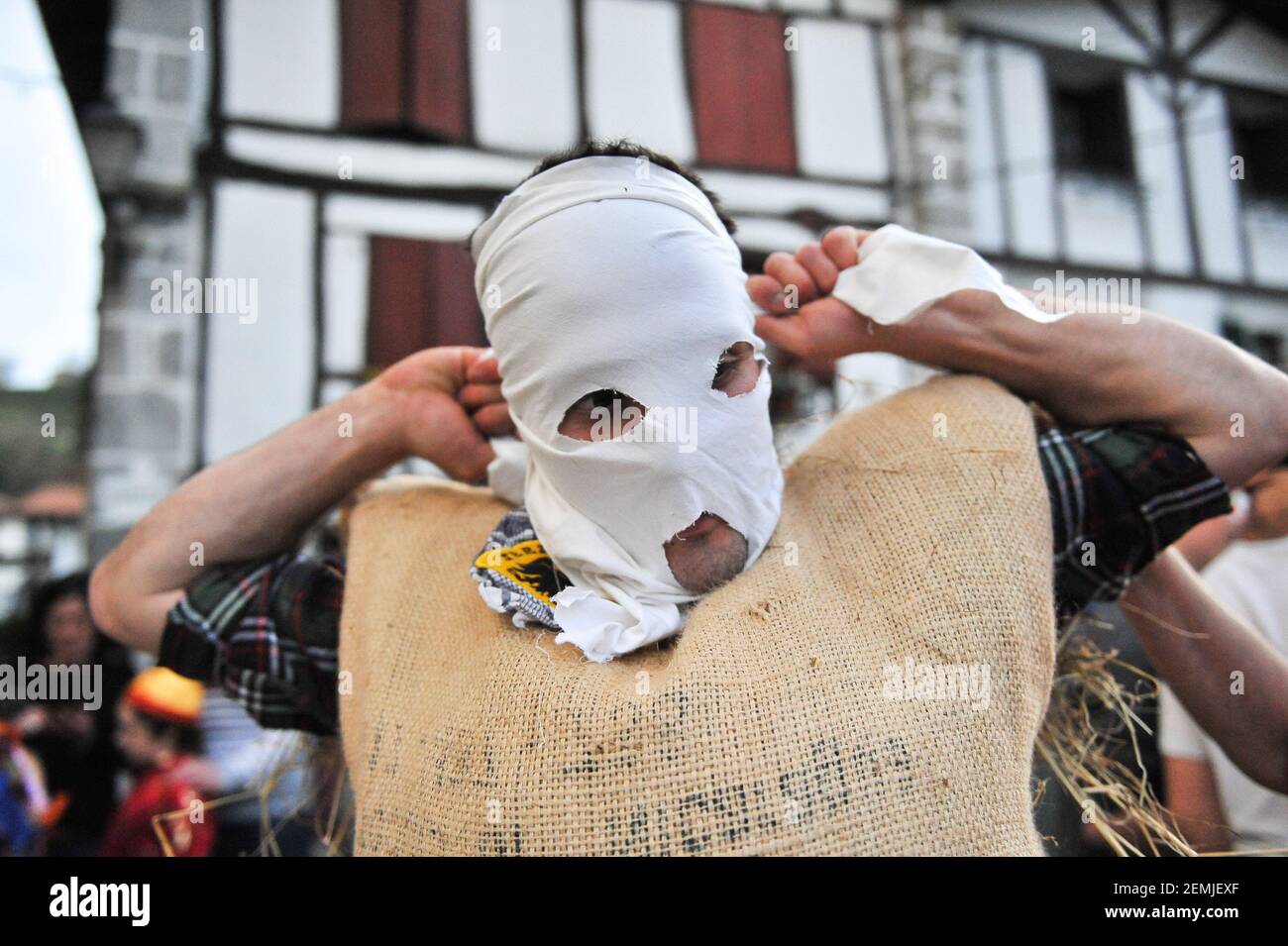 A zakuzaharrak seen making his typical mask, which consists of a white  handkerchief during the Lesaka Carnival. The "zaku-zaharrak" is a  traditional carnival characters festival in the small town of Lesaka.  Stuffed into sacks full of straw with their faces ...