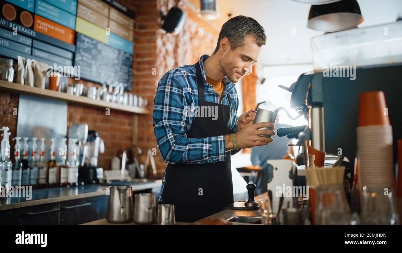 https://c8.alamy.com/comp/2EMJHDN/handsome-male-barista-in-checkered-shirt-is-making-a-latte-for-a-customer-in-a-coffee-shop-bar-beautiful-caucasian-male-cashier-works-at-a-cozy-loft-2EMJHDN.jpg