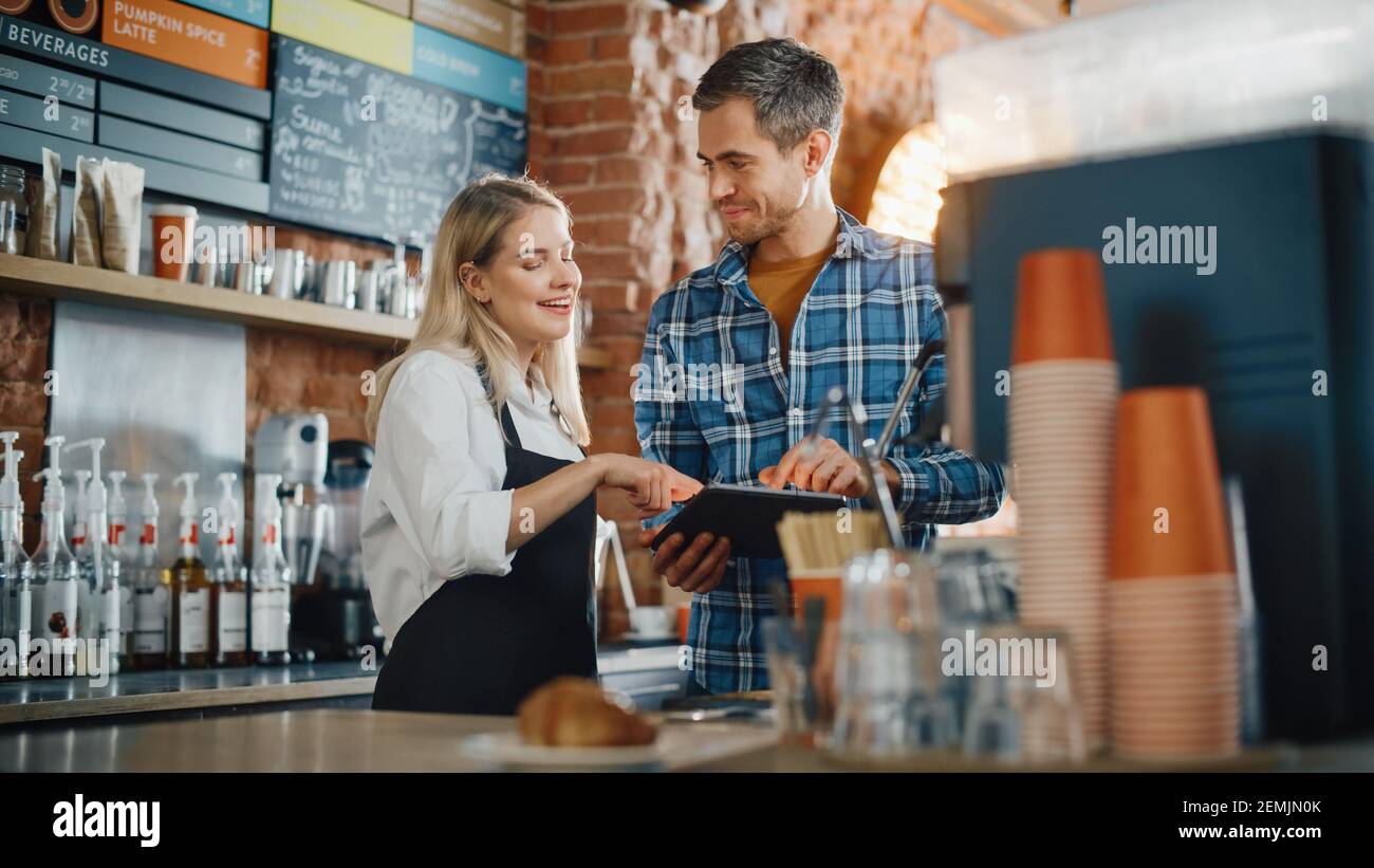 Two Diverse Entrepreneurs Have a Team Meeting in Their Stylish Coffee