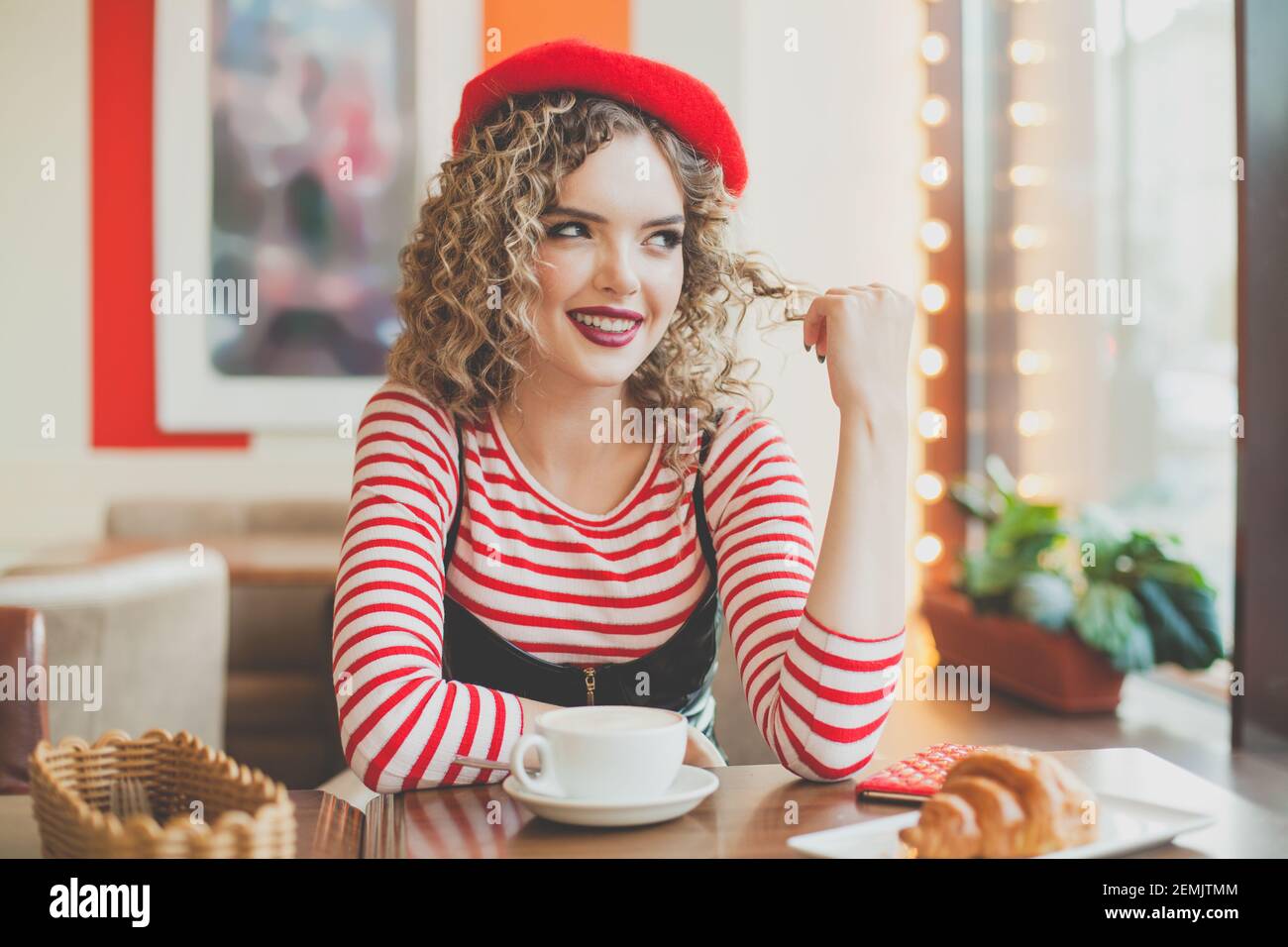 Woman sitting in a cafe france hi-res stock photography and images