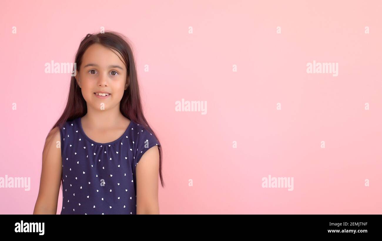 Portrait of a little girl pink background Stock Photo - Alamy