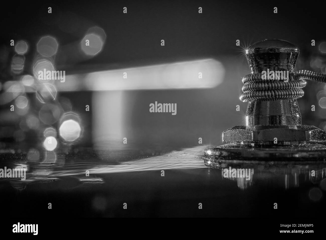 Black & white macro of a guitar tuning peg with string - background bokeh Stock Photo