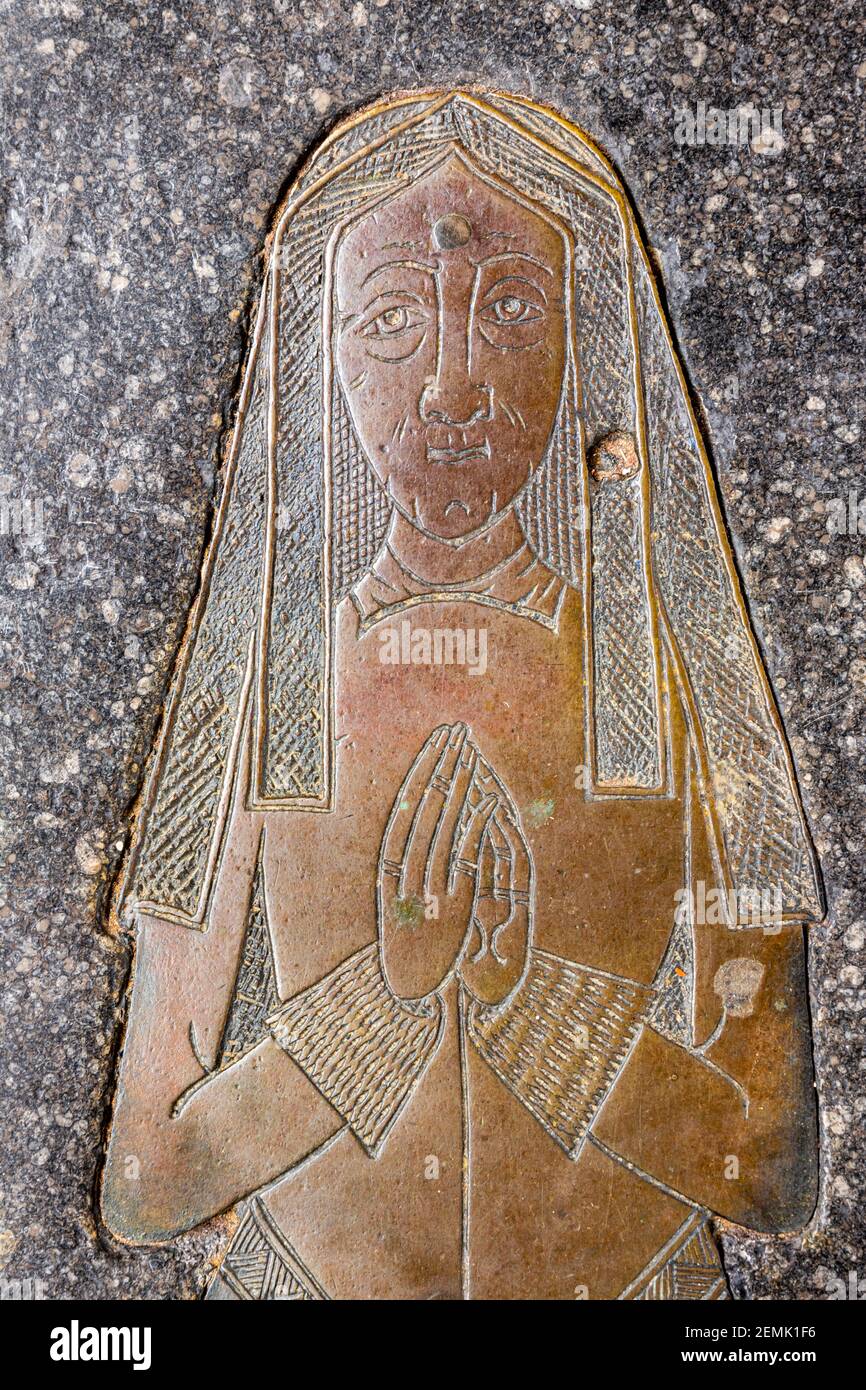 A detail of the memorial brass of Joan Bushe wife of the wool merchant Thomas Bushe (c. 1525) in the church in the Cotswold town of Northleach, Glos. Stock Photo
