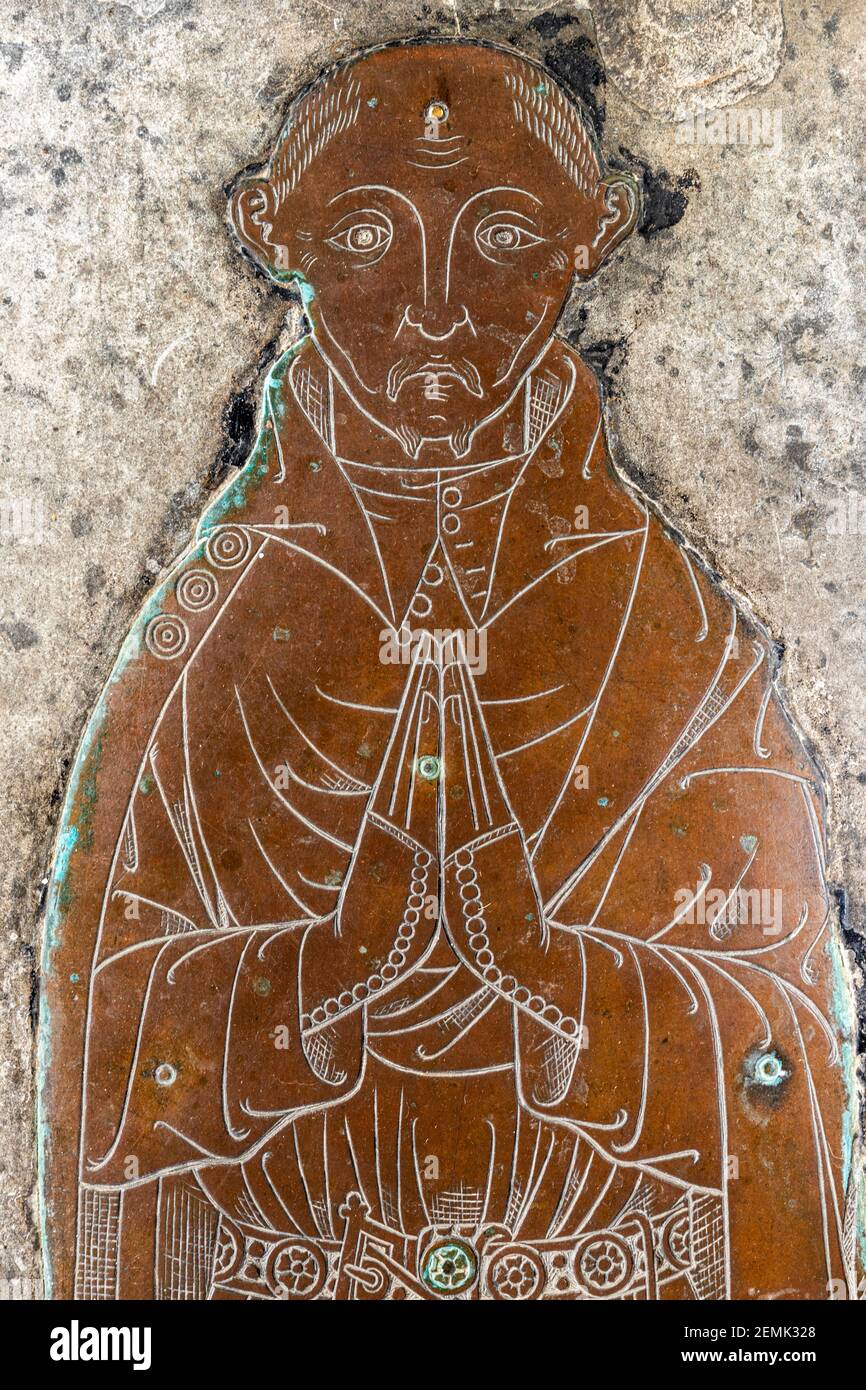 A detail of a memorial brass of an unknown wool merchant (c..1400) in the church in the Cotswold town of Northleach, Gloucestershire UK. Stock Photo