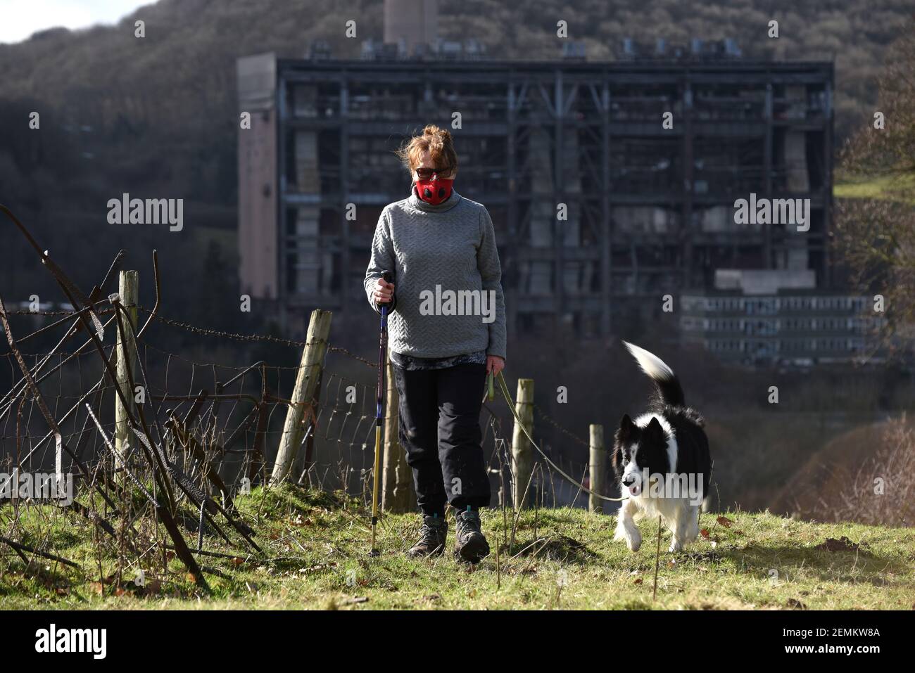 Covid fear walker wearing face mask. A woman walking her dog near the disused Buildwas Power station in the Ironbridge Gorge wears a protective face mask during the Covid pandemic lockdown. Credit: Dave Bagnall/Alamy Live News Stock Photo