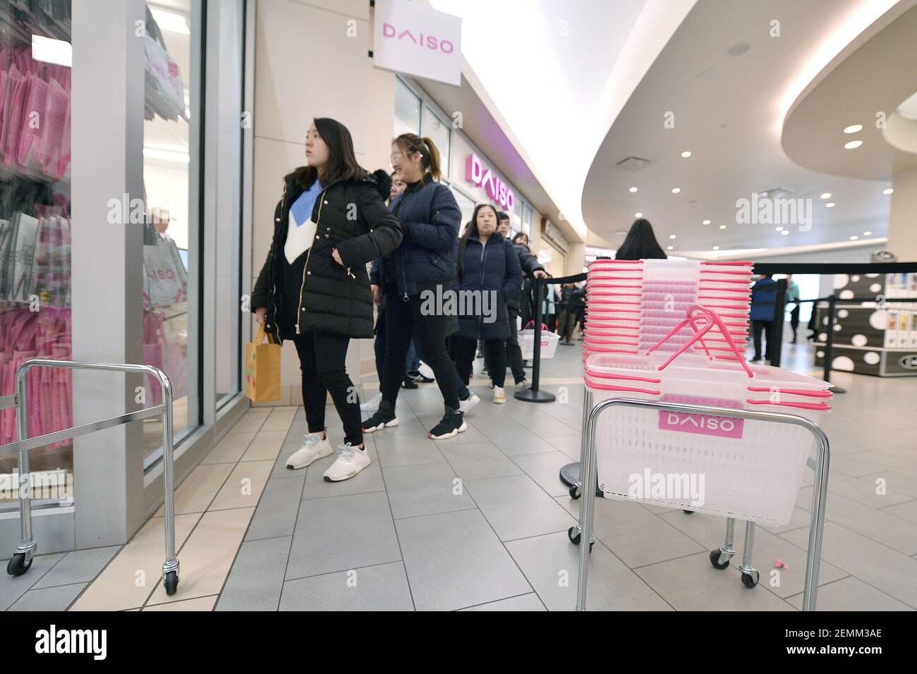 Shoppers wait in line to enter the newly opened Daiso, japanese "dollar