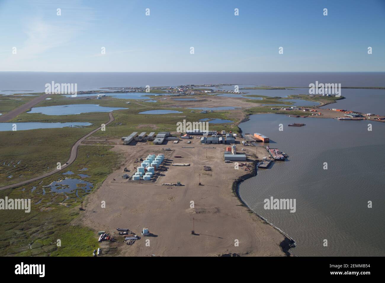 Aerial summer view of coastal Tuktoyaktuk surrounded by Arctic Ocean, threatened by soil erosion, rising sea levels, Northwest Territories, Canada. Stock Photo