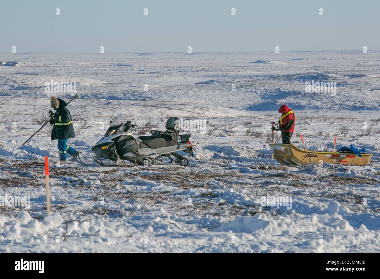 Surveyors at work on the frozen tundra during winter construction of the Inuvik-Tuktoyaktuk Highway, Northwest Territories, Canada's Arctic. Stock Photo