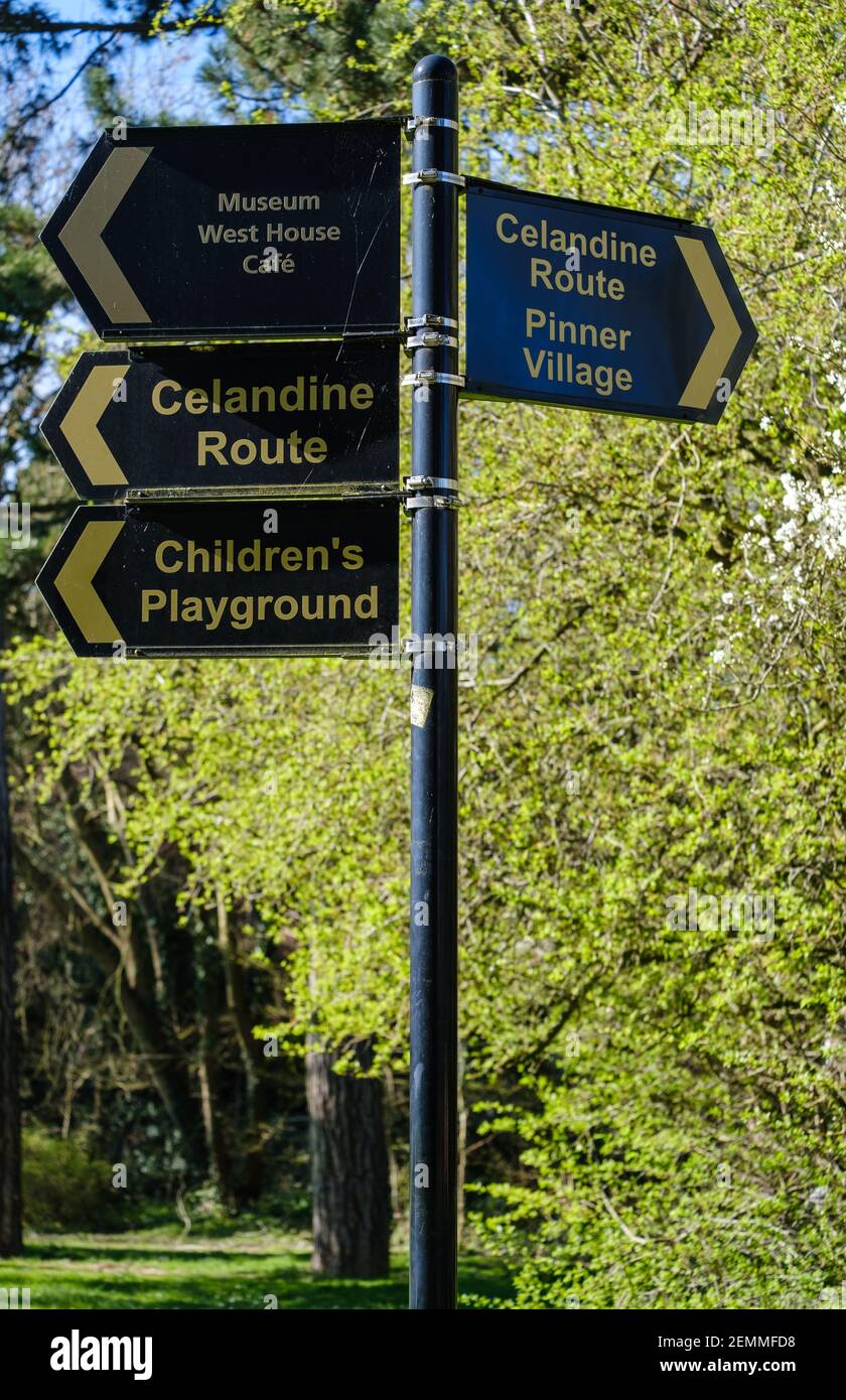 Pole with 4 signs in Pinner Memorial Park, pointing out Children’s Playground, Celandine Route