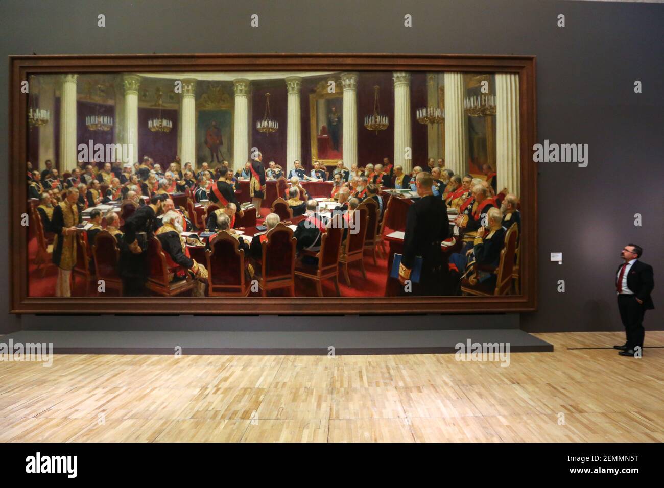 A visitor seen examining the artwork "Ceremonial Meeting of the State