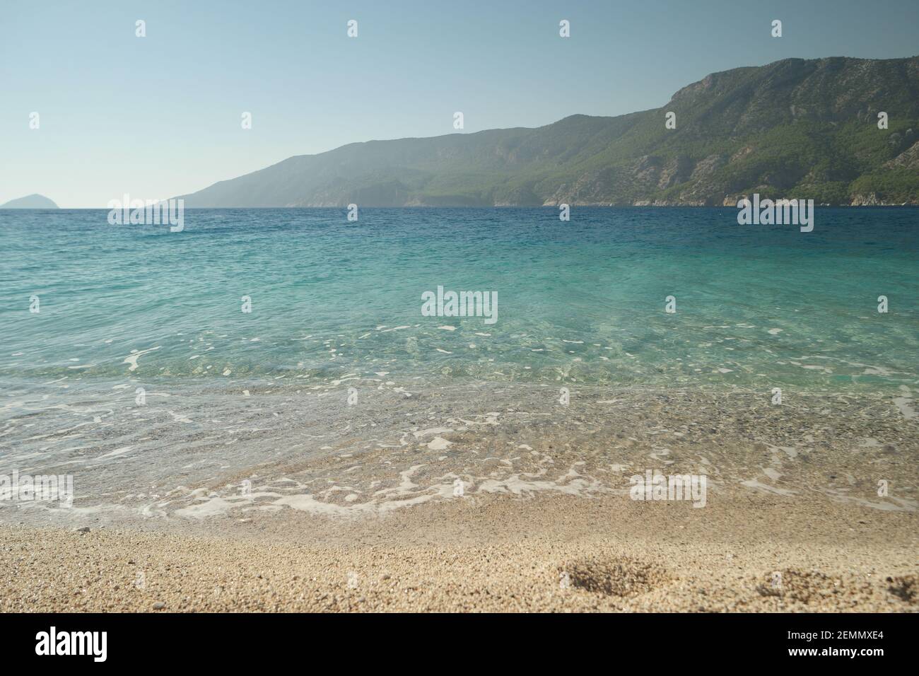 Sandy beach with crystal clear sea water Stock Photo - Alamy