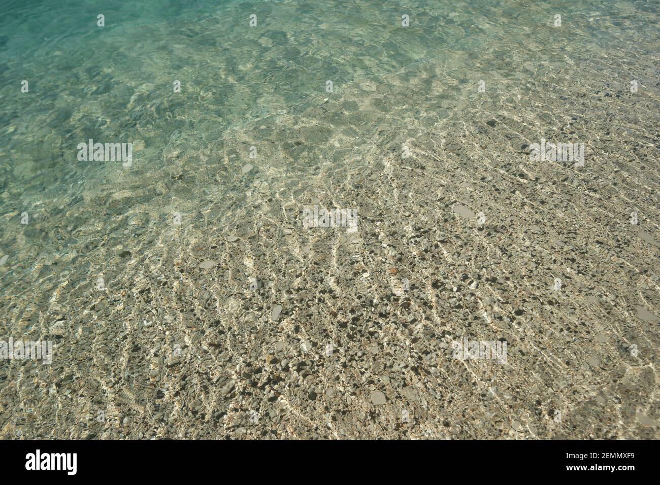Pebbles in transparent sea water Stock Photo - Alamy