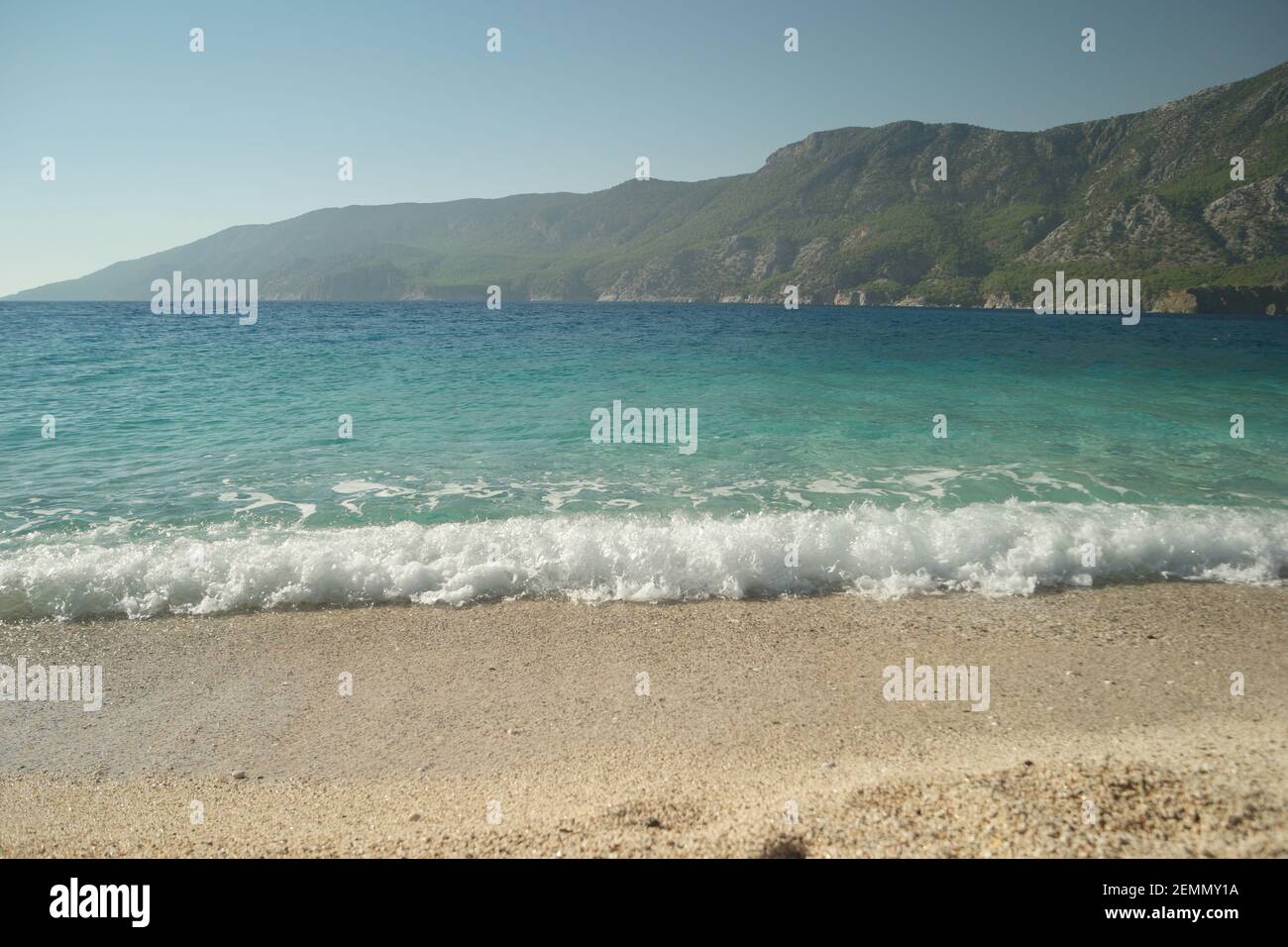 Beautiful tropical beach with white foam sea waves Stock Photo - Alamy