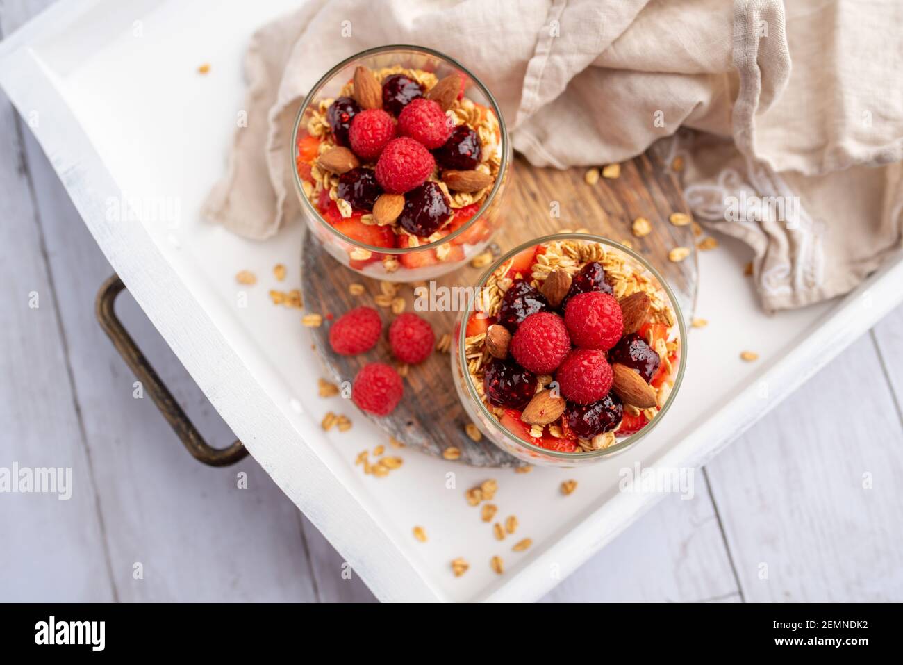 Greek yogurt raspberry parfaits in glass jars, small healthy dessert