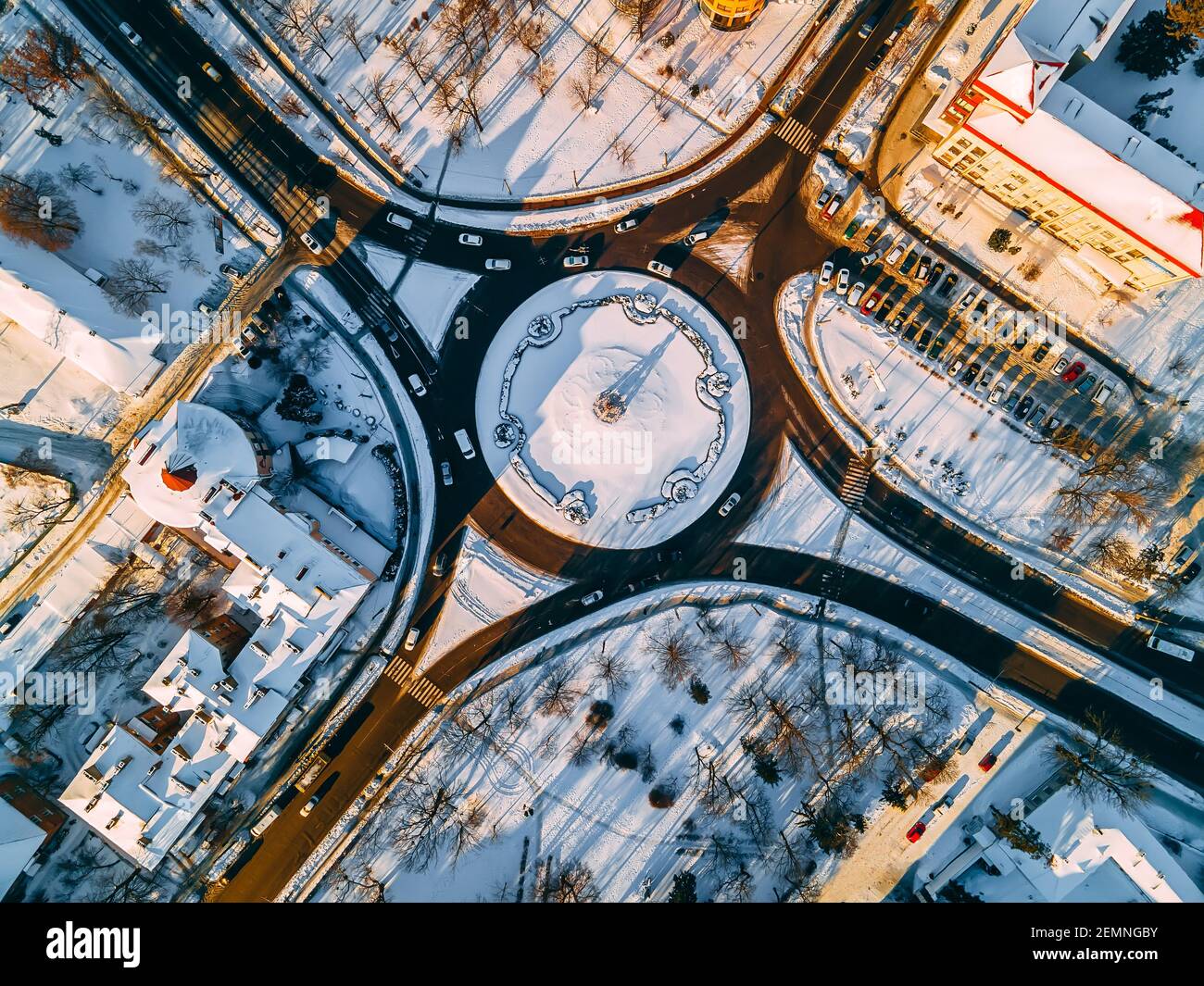 Aerial view of roundabout road with circular cars in small european city at winter sunny day. Kyiv region, Ukraine Stock Photo