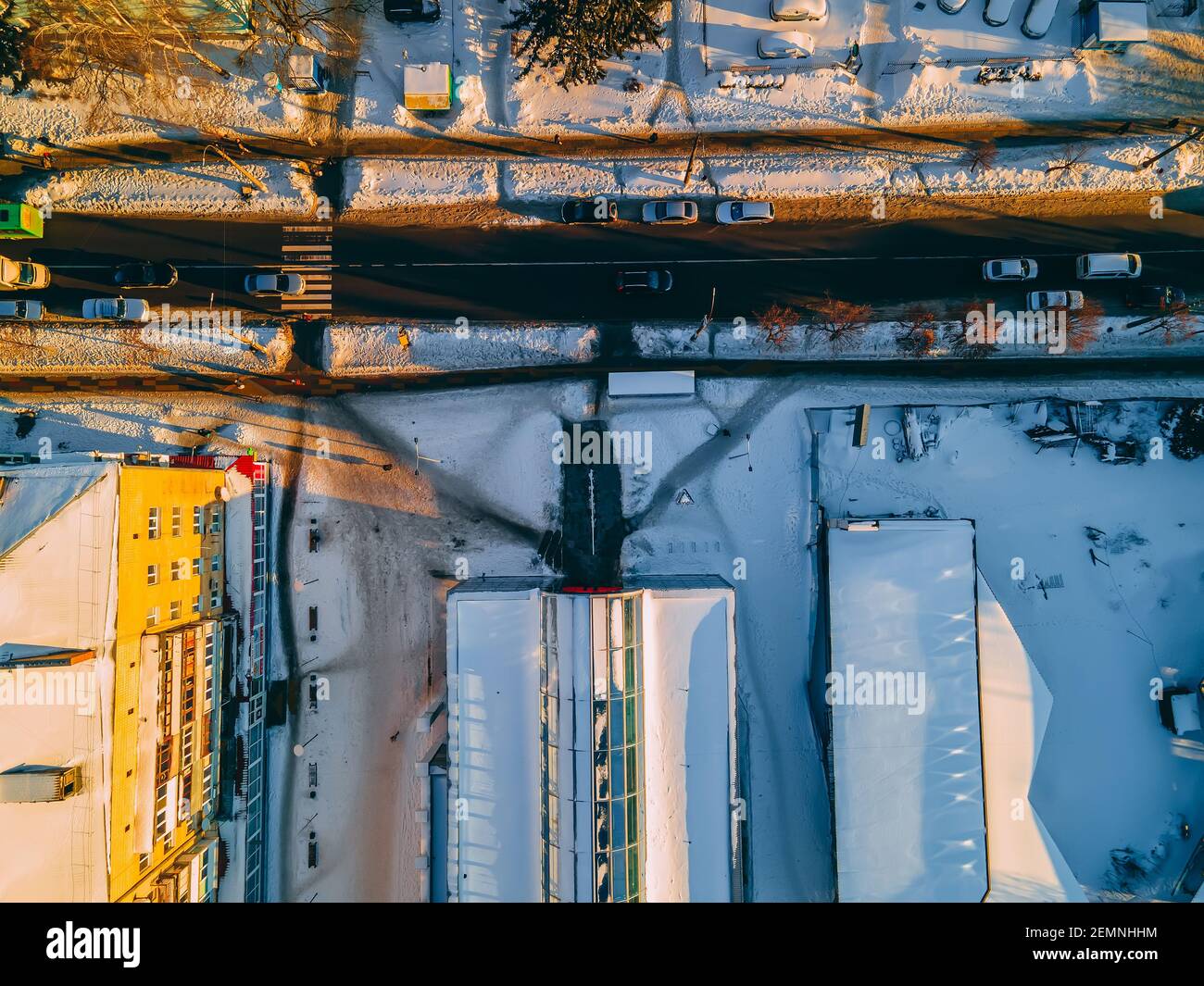 Top down aerial view of road near supermarket in small european city at winter sunny evening, Ukraine, Europe Stock Photo