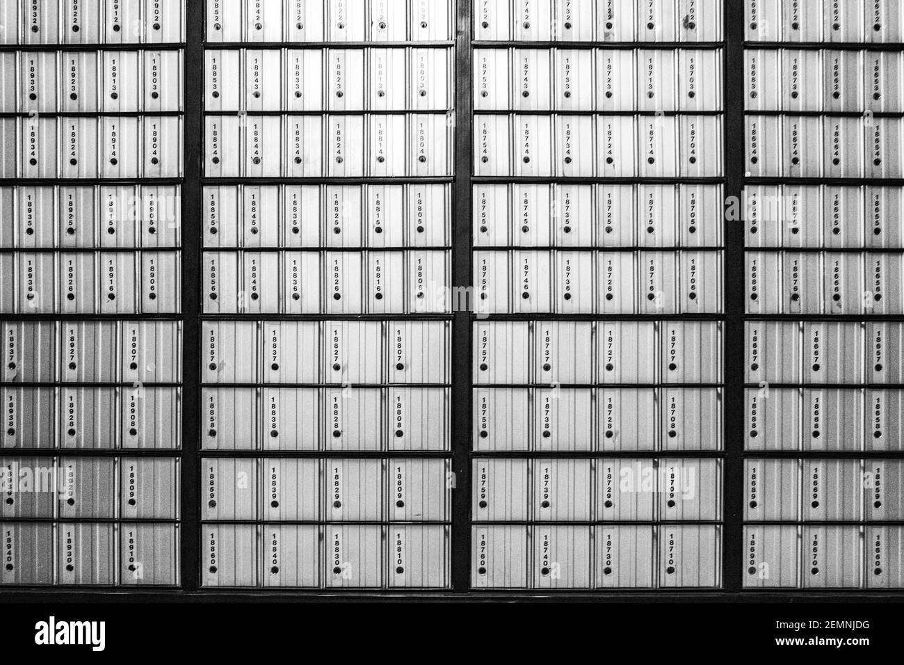 Post office boxes on a wall create a grid of lines at a branch of the