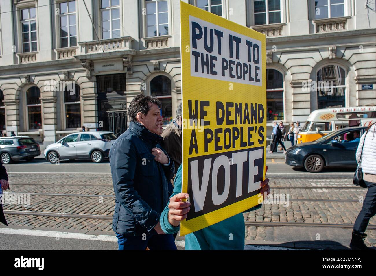 A man is holding a huge placard in front of him during the March for Europe celebrated in Brussels, on March 24th, 2019. A day before the anniversary of the founding Treaty of the European Union, citizens and civil society organizations took the streets of Brussels to make a stand, two months before the European elections. The march was organized by Together platform, an initiative launched by an alliance of progressive political groups from across Europe. They stand for solidarity, democracy, and peace against the real threat to their core European values.(Photo by Romy Fernandez/Sipa USA) Stock Photo