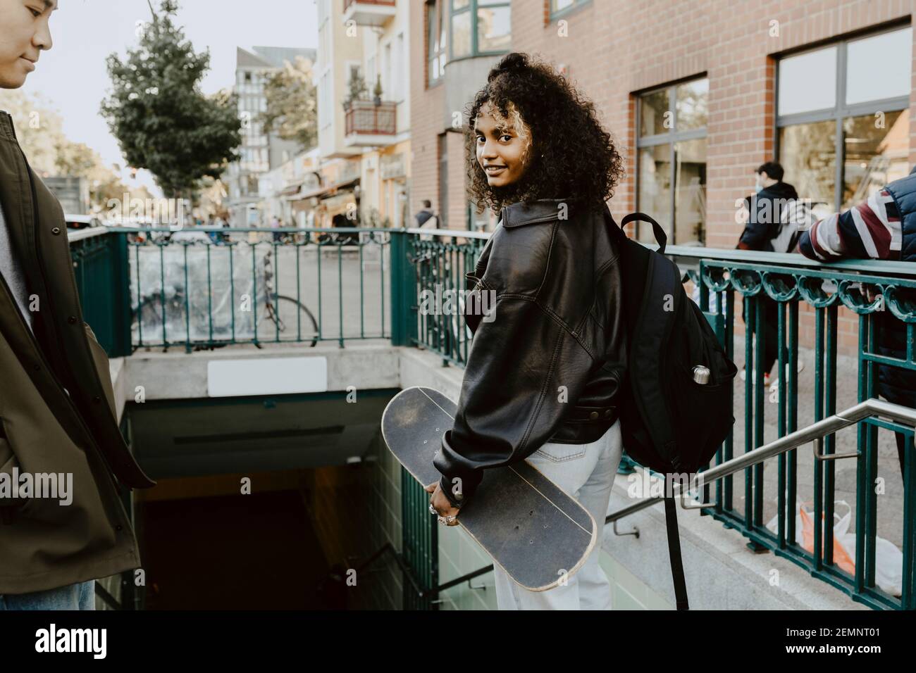Young friends standing on steps in city Stock Photo