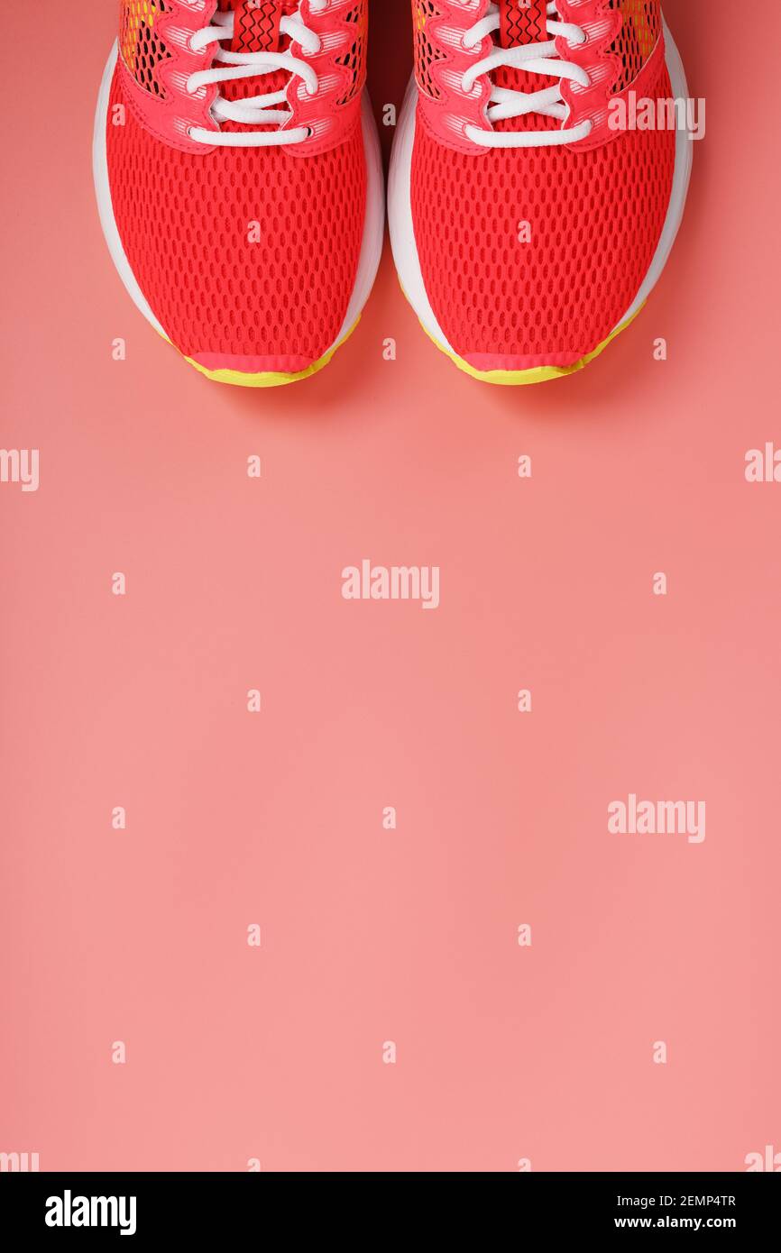 Sports pink sneakers on a pink background with free space. Top view ...