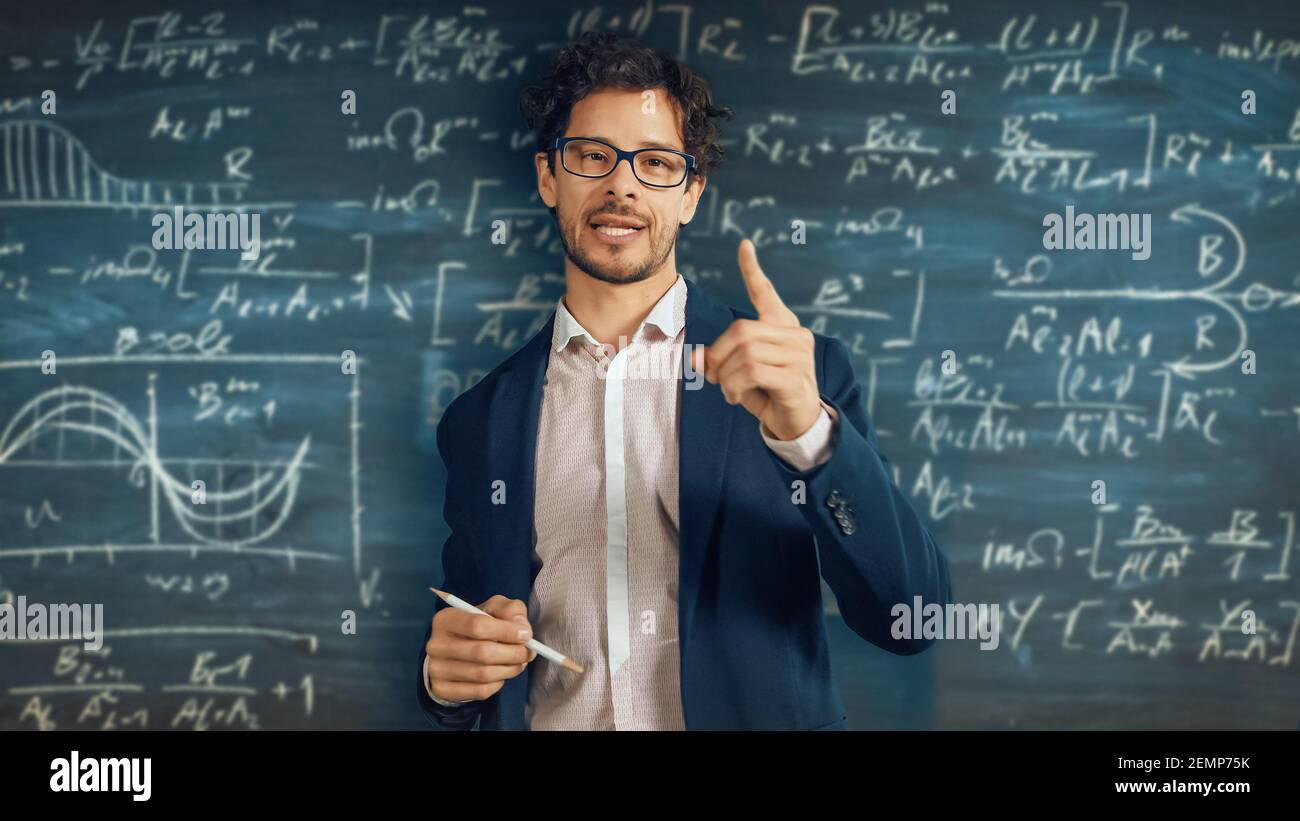 Online e-Education Concept: Teacher Explaining Lesson to a Classroom, Behind Him Blackboard with Writing. e-Learning, Online Courses: Lecturer does Stock Photo