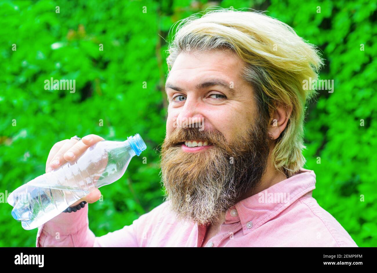 Bearded man drinking water. Male with bottle. Healthy lifestyle. Drinks water. Hydration concept. Stay hydrated. Stock Photo