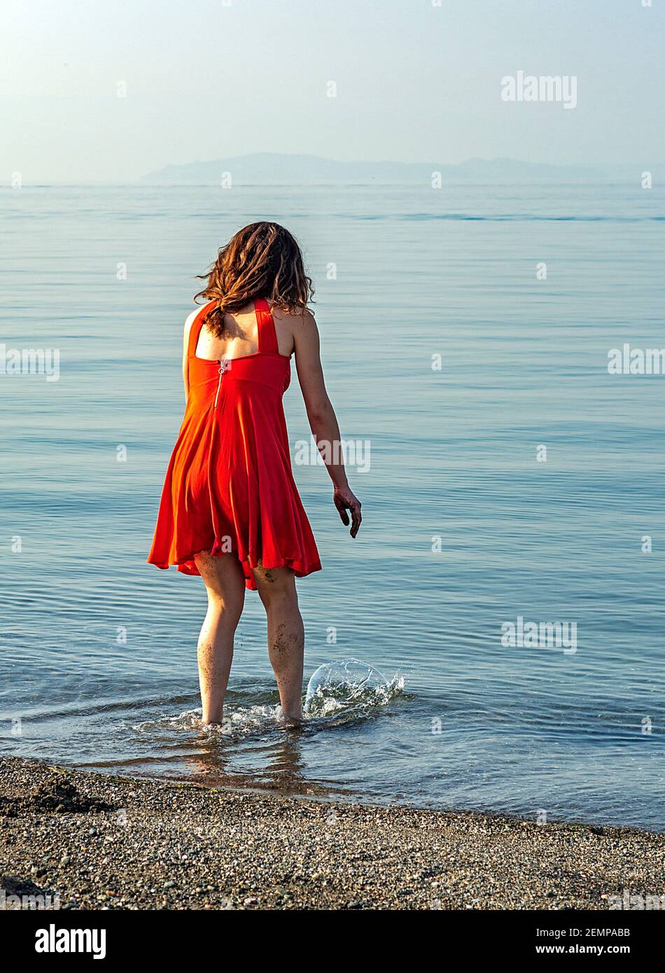 Girl kneeling in the sand hi-res stock photography and images - Alamy