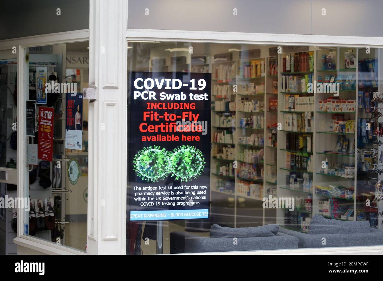 London, England, UK. 25th Feb, 2021. A sign on a pharmacy window is seen which reads as 'Covid-19 PCR swab test including fit-to-fly certificate available here.'' The sign announces that the antigen test kit used for this pharmacy service is also being used within the UK government''s national covid-19 testing programme. Today UK authorities lowered the covid-19 threat level as the number of cases and death kept decreasing and vaccine roll out progressed rapidly over the last weeks. Credit: Tayfun Salci/ZUMA Wire/Alamy Live News Stock Photo