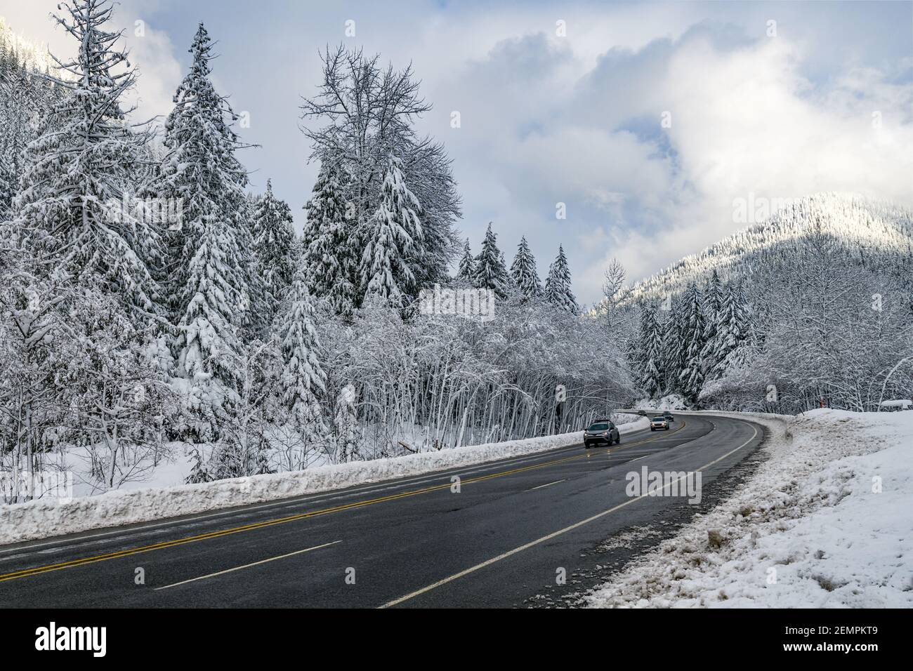 Cars descend down the west side of Stevens Pass on Highway 2 in Washington state after snow Stock Photo