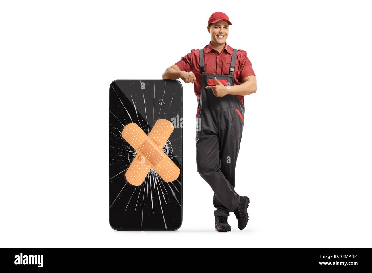 Mobile phone technician leaning on a smartphone with a cracked screen and band aid and pointing isolated on white background Stock Photo