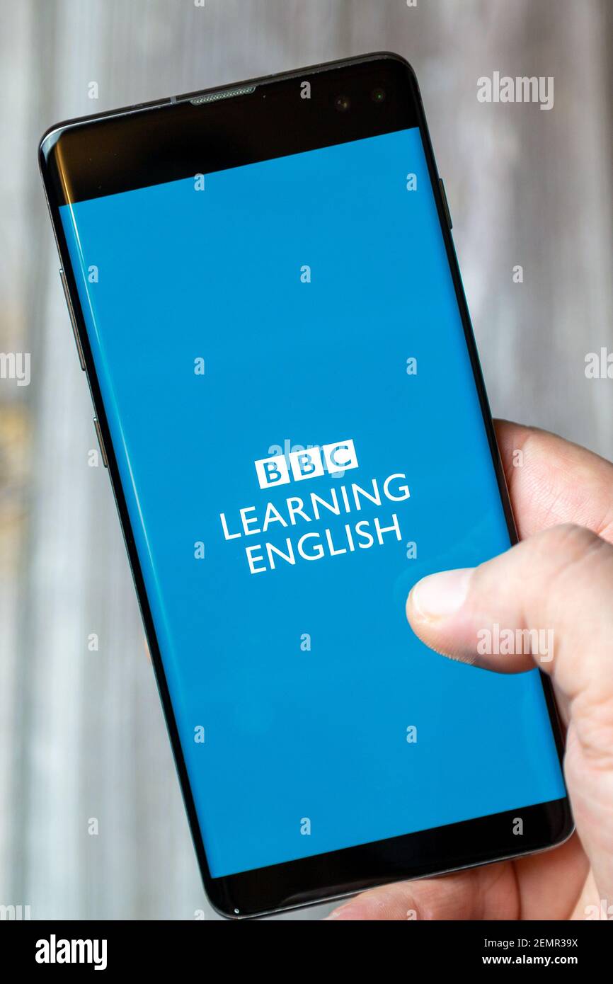 A mobile phone or cell phone being held by a hand with the BBC Learning ...
