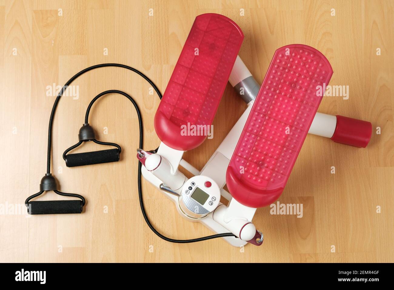 Fitness stepper or cardio training with digital display on the floor. Workout at home during pandemic and quarantine. Keep fit. Home gym equipment Stock Photo