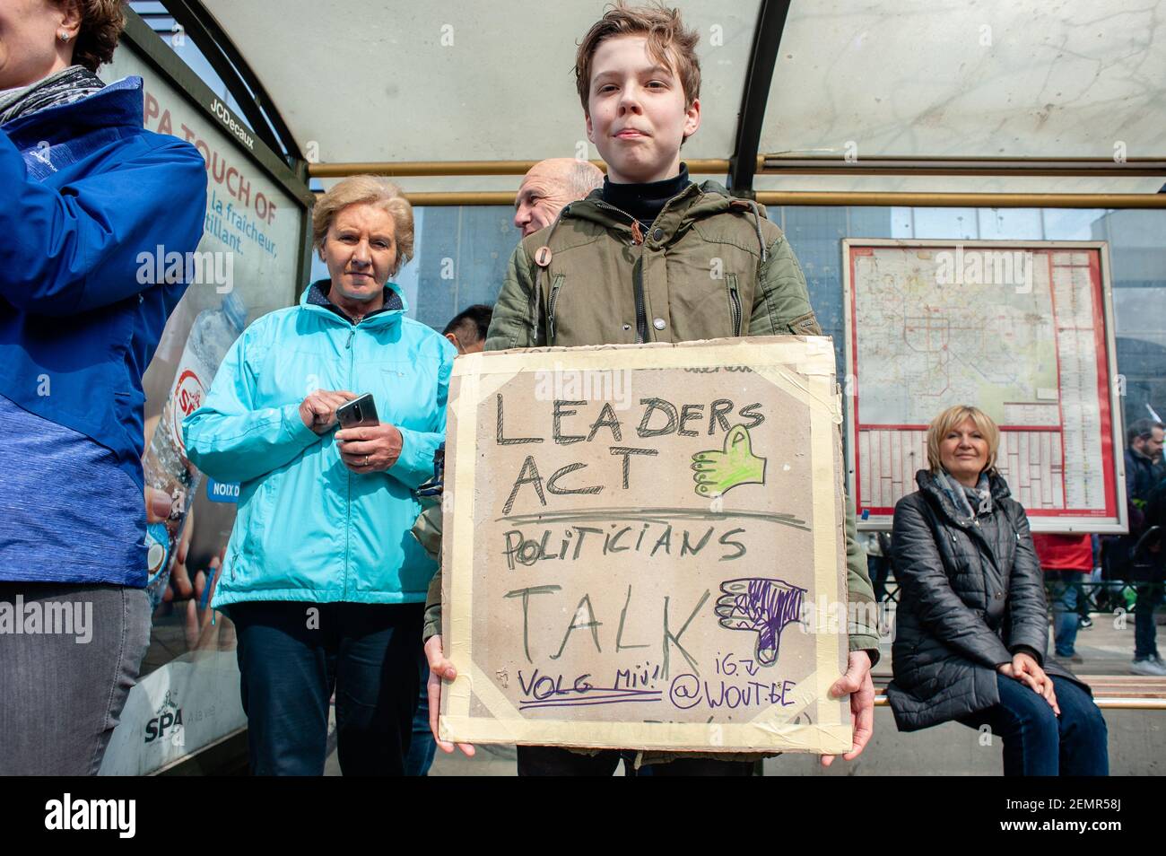 A boy is seen holding a placard during the demonstration. Thousands of people gathered as always at the Brussels North station to demand a declaration of a state of environmental emergency and a climate law to reduce C02 emissions by 55% by 2030, the climate as a top priority, the adoption of the Finance-Climate Pact, the respect of the Paris agreements and the protection of water and forests. (Photo by Ana Fernandez / SOPA Images/Sipa USA)  Stock Photo