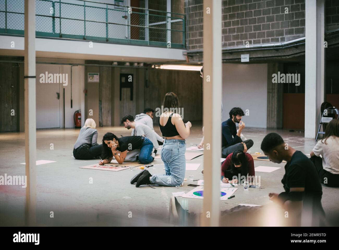 Male and female protestors preparing signboards for social issues in building Stock Photo