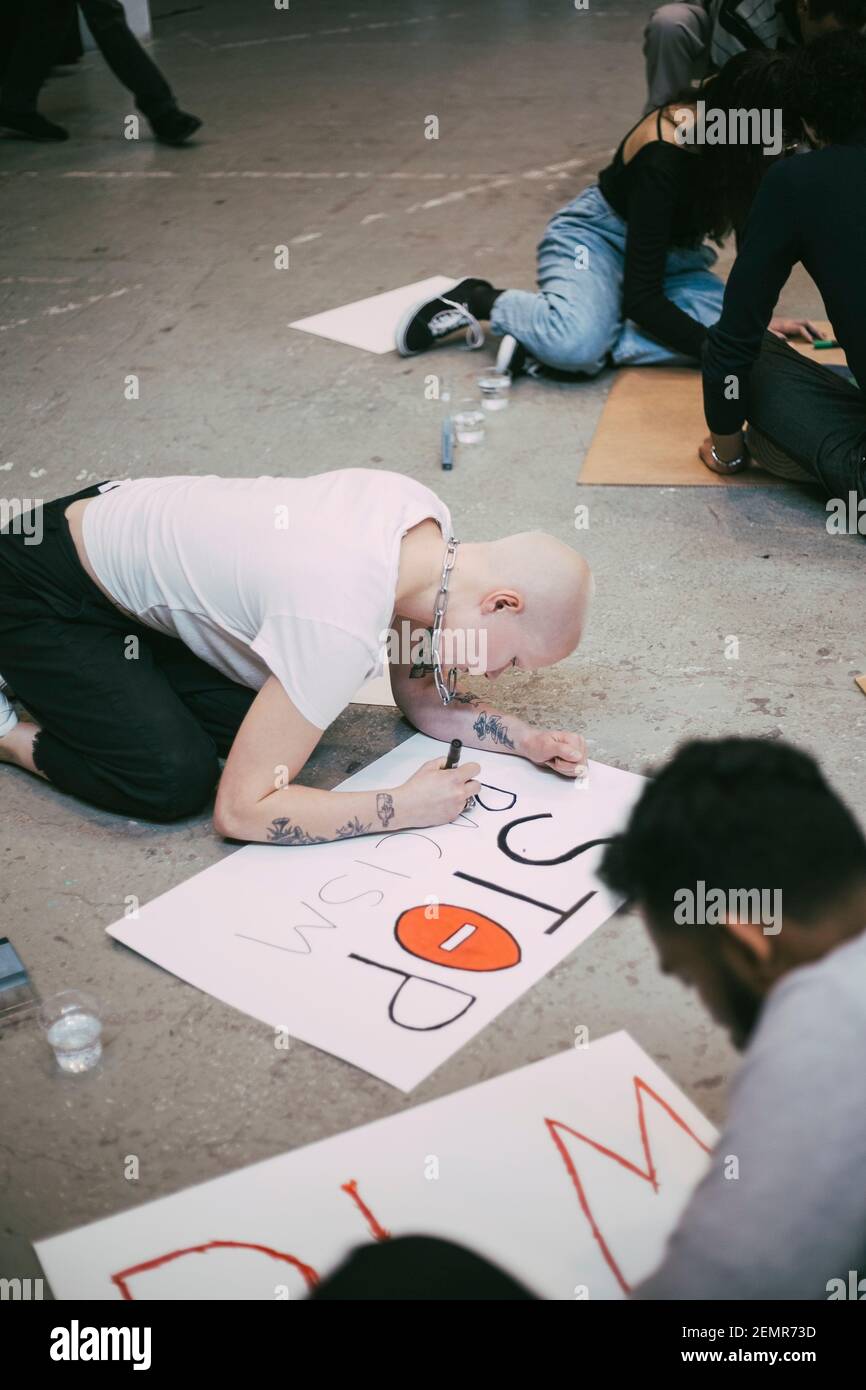 Male and female activist making sign of stop racism Stock Photo