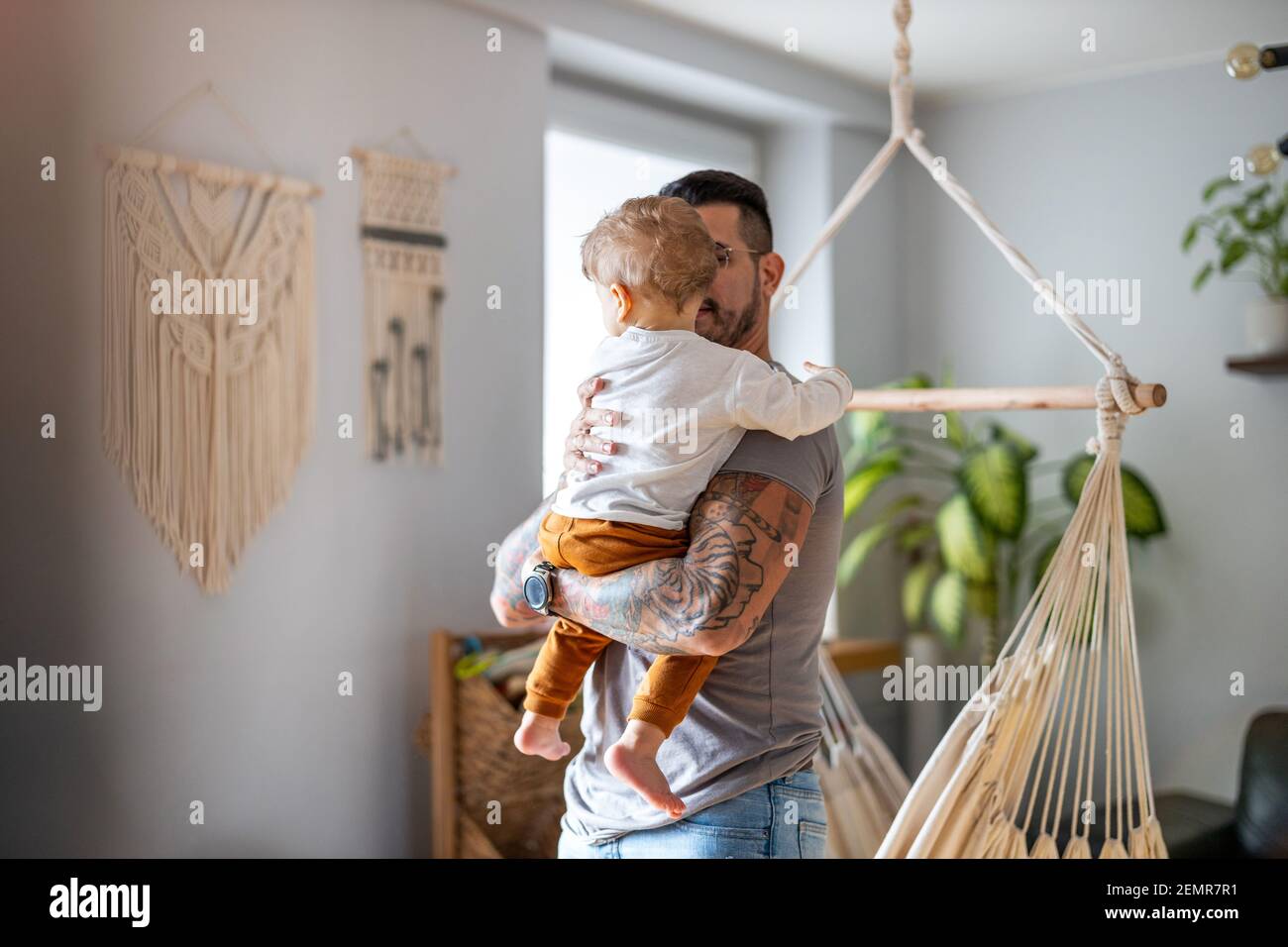 Father looking after his small son at home Stock Photo