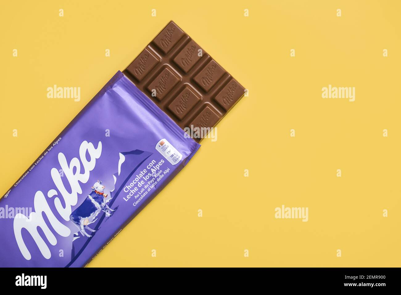 Milka milk chocolate bar tablet on yellow background Stock Photo