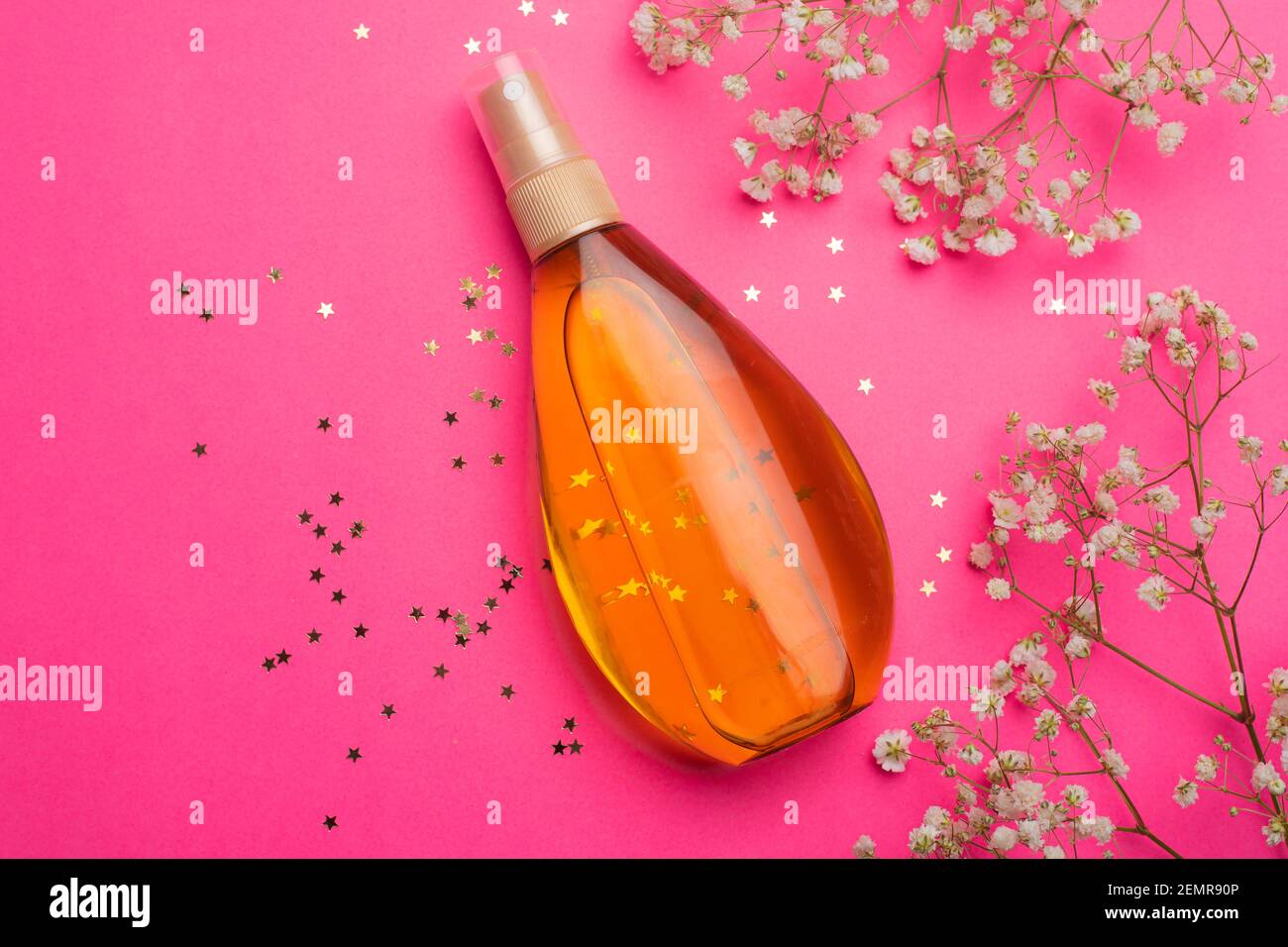 Suntan oil on a pink background. Uniform tan. A bottle of suntan oil . Protection of the skin. Vacation. Article about the choice of tanning products Stock Photo