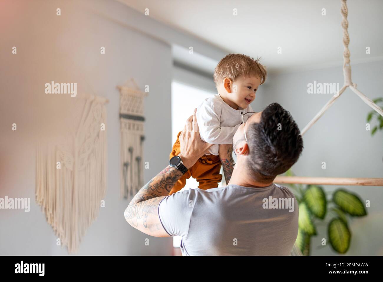 Father and baby son having fun together at home Stock Photo