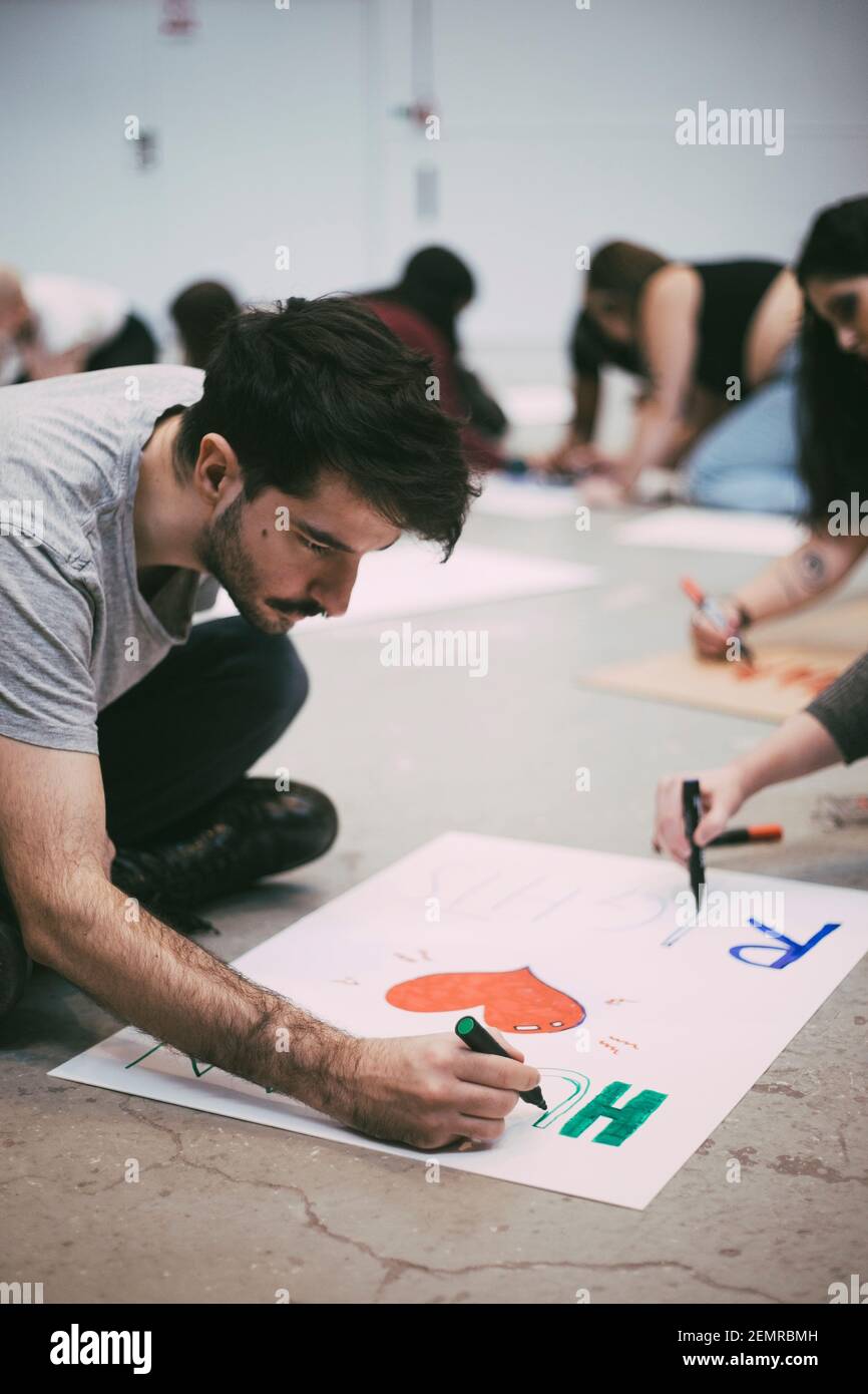 Young man preparing signboard to protest against equal rights Stock Photo