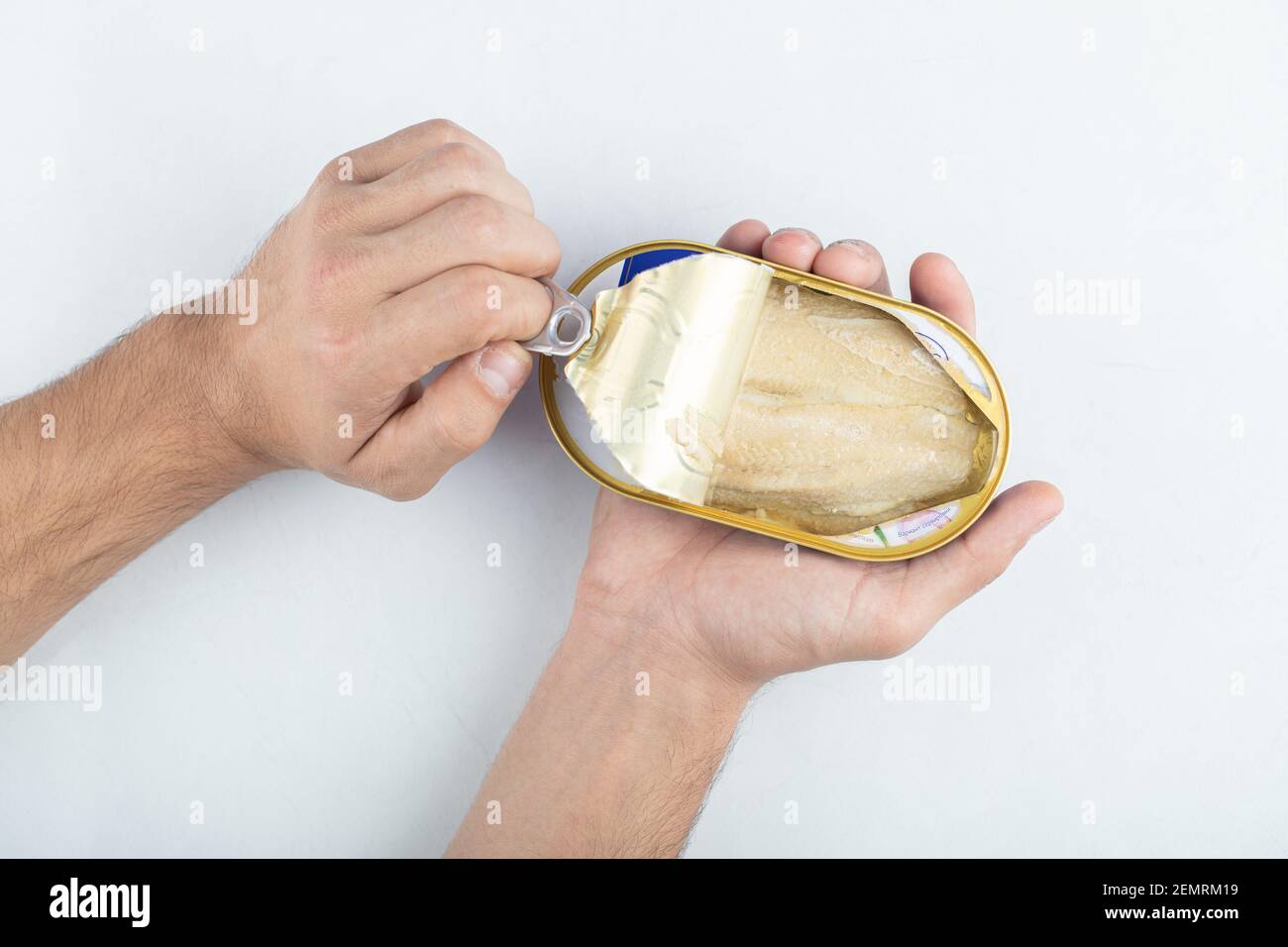 Man opening canned fish. White packed meat Stock Photo Alamy