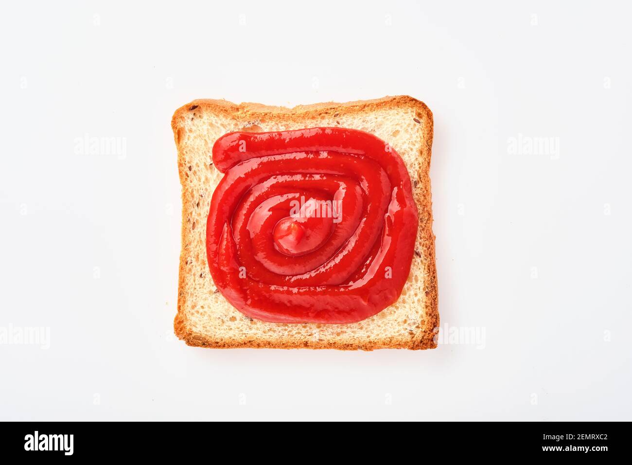 Bread slice with ketchup isolated on white. Slice of multigrain bread square form plaster tomatoes sauce for toast. Top view or flat lay. Stock Photo