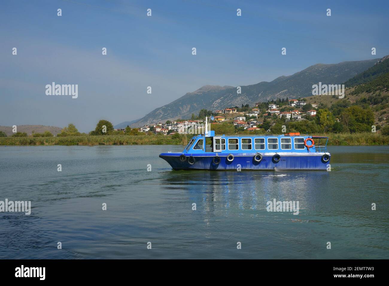 Landscape with a traditional tour boat on Pamvotis Lake in Ioannina, Epirus Greece. Stock Photo