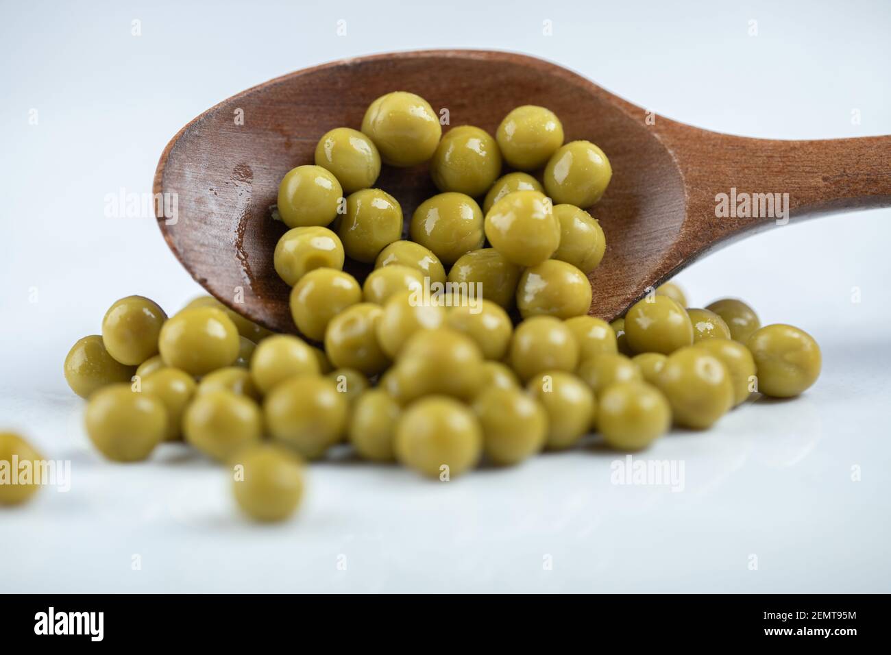 Green olives on white background. wooden spoon Stock Photo - Alamy
